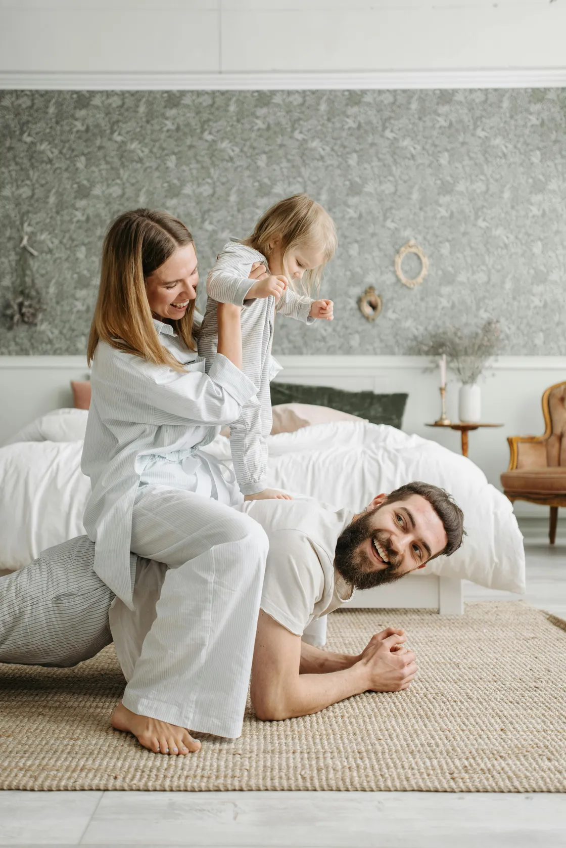 Florida couple spending casual time with their young daughter at home, representing second-time parents reviewing their life insurance ladder