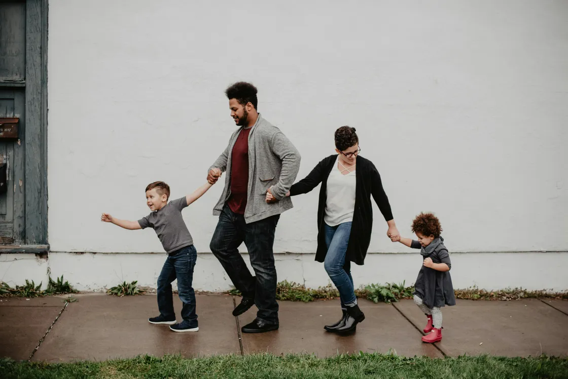 Family of four walking together outdoors