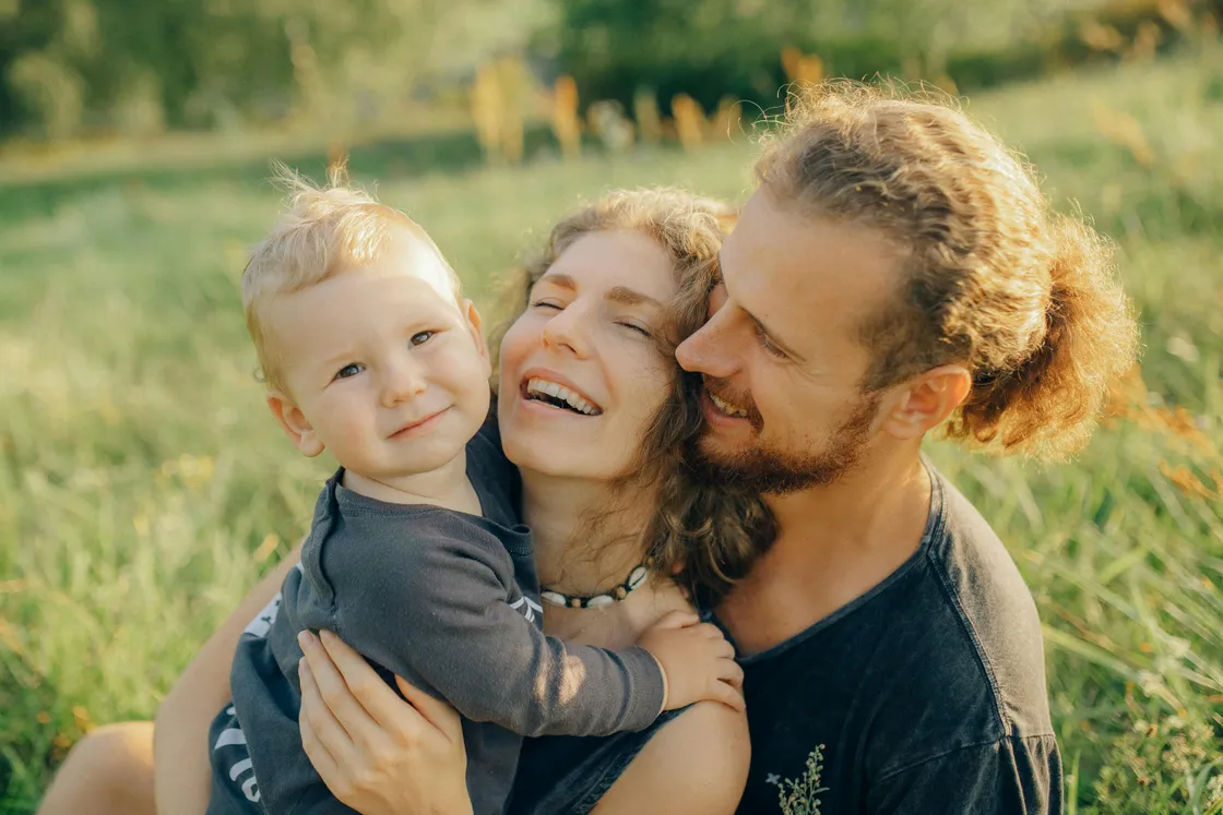 Young couple with their child in a park